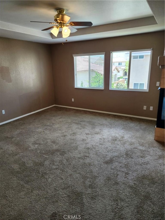 unfurnished room with carpet, baseboards, and a ceiling fan