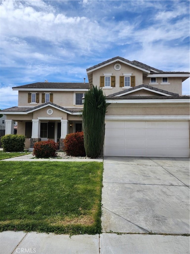 traditional-style home featuring a front yard, driveway, and stucco siding