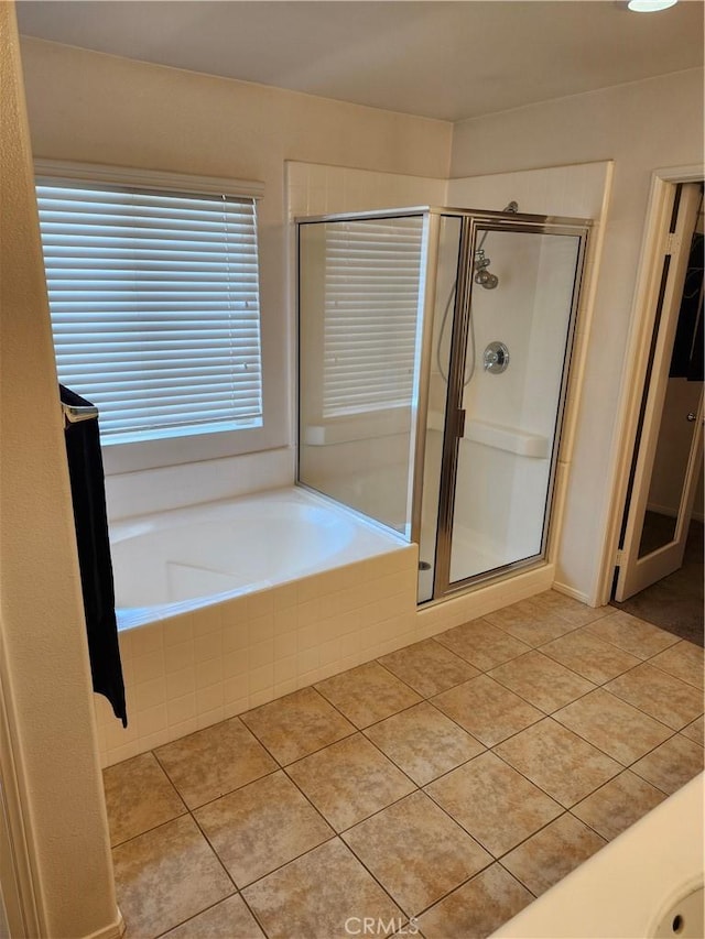 full bath featuring a shower stall, tile patterned floors, and a bath