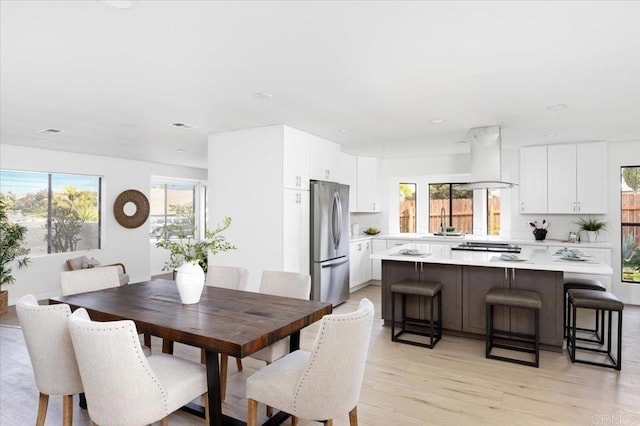 dining area featuring visible vents and light wood finished floors