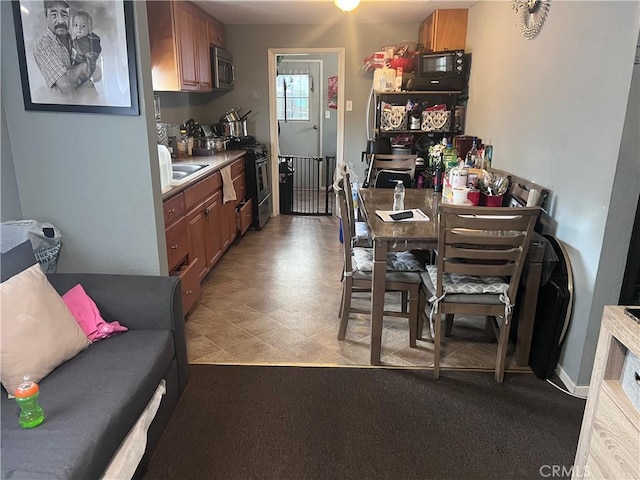 kitchen featuring brown cabinetry and stainless steel microwave