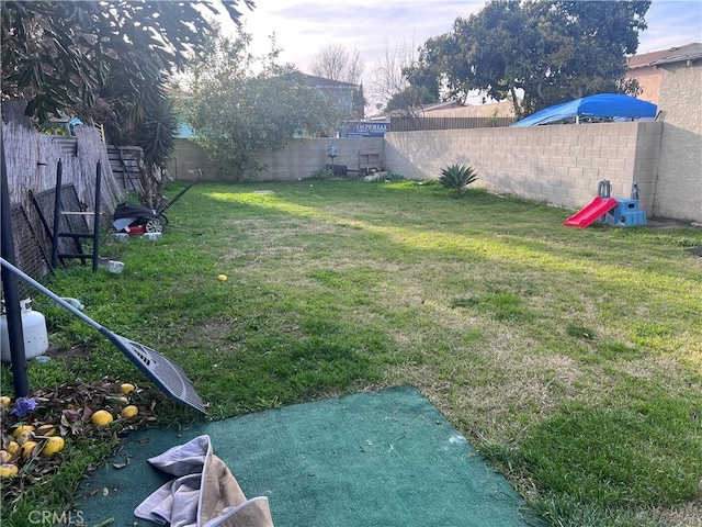 view of yard with a fenced backyard