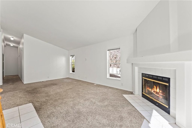 unfurnished living room with light carpet and a fireplace