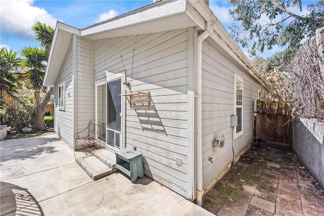 view of home's exterior featuring a patio and fence