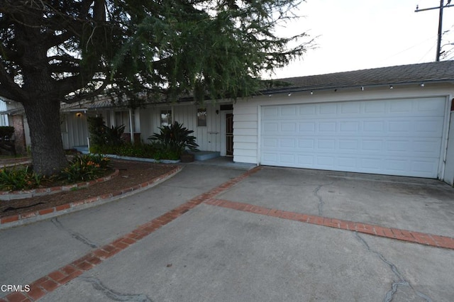 ranch-style house with driveway and a garage