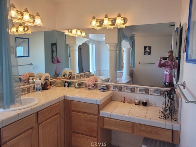 bathroom with vanity and decorative columns