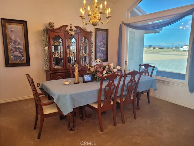 dining room featuring baseboards, carpet, and a chandelier