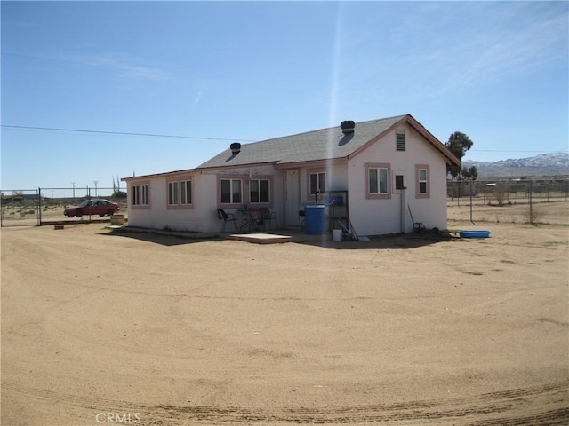 view of front of property with fence and stucco siding