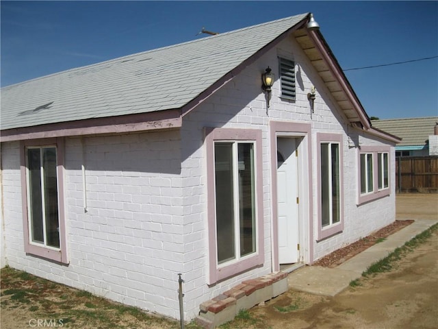 view of home's exterior with fence