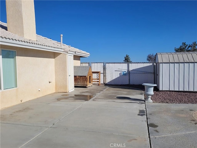 view of patio with a gate and fence