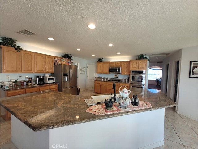 kitchen with recessed lighting, visible vents, appliances with stainless steel finishes, and a sink