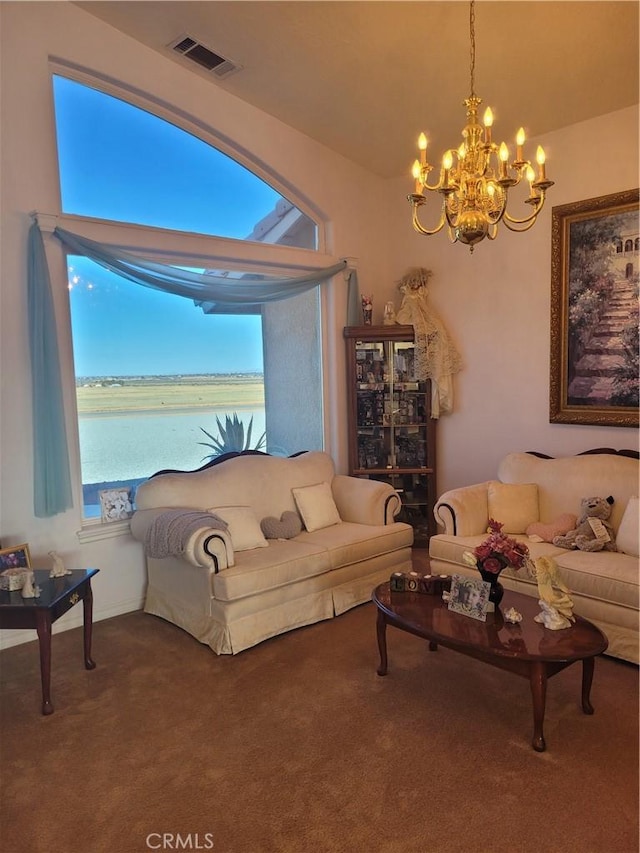 living area featuring a notable chandelier, visible vents, and carpet floors