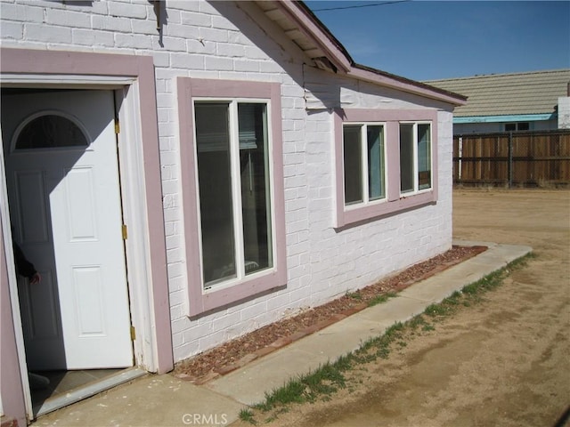 view of home's exterior featuring fence