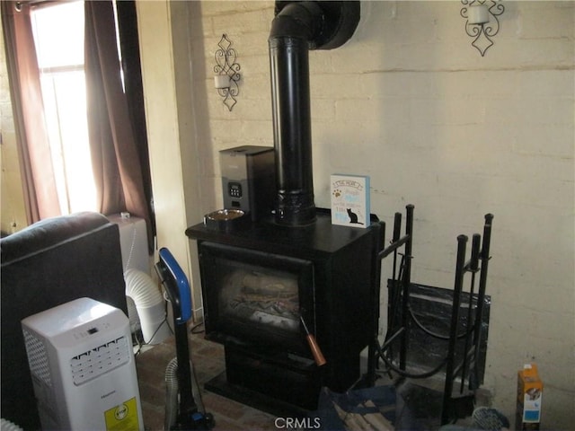 room details with concrete block wall and a wood stove