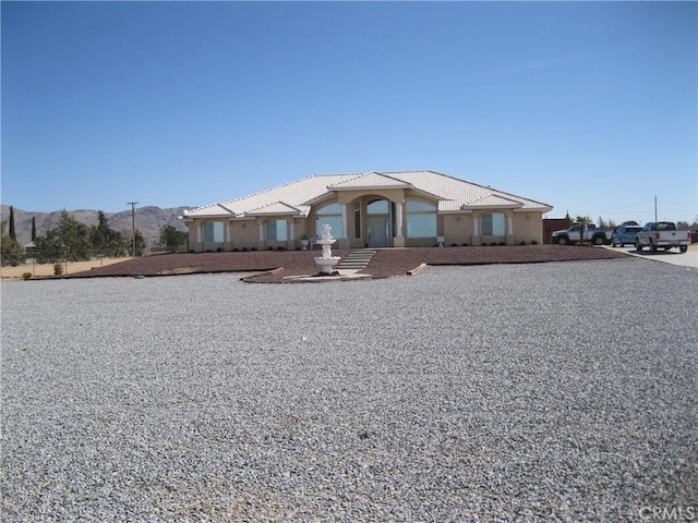 view of front of house with stucco siding and a tiled roof