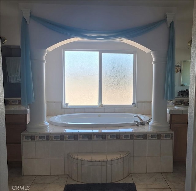 bathroom featuring vanity, a garden tub, and decorative columns