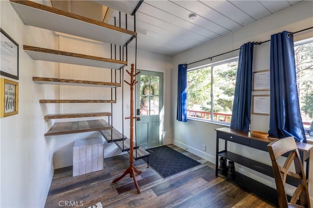 entryway with stairway, baseboards, and wood finished floors