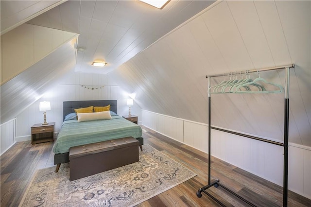 bedroom featuring wood finished floors and vaulted ceiling