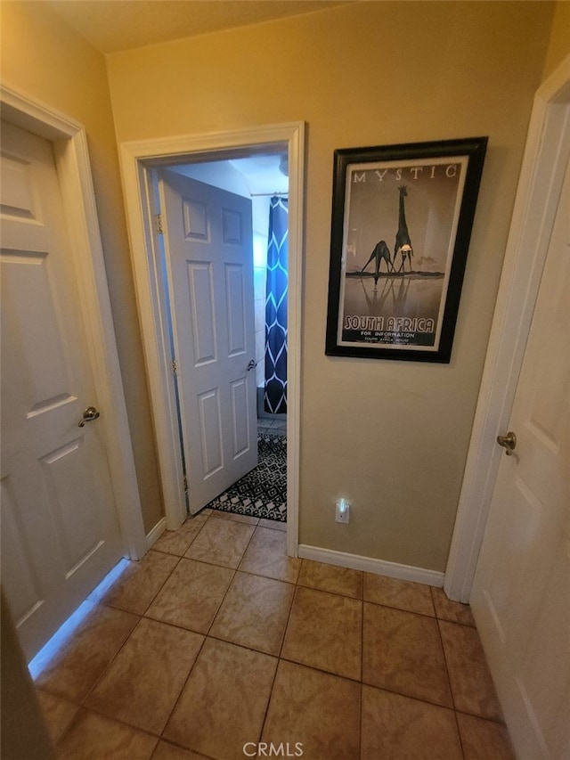 entryway featuring baseboards and light tile patterned floors