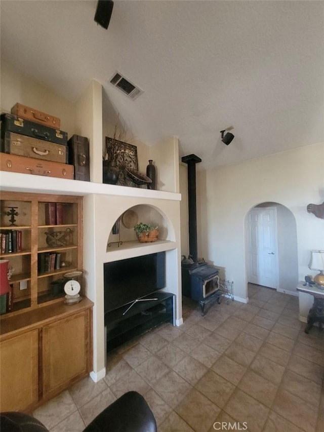 living area featuring a wood stove and arched walkways