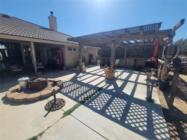 view of patio with an outdoor fire pit and a pergola