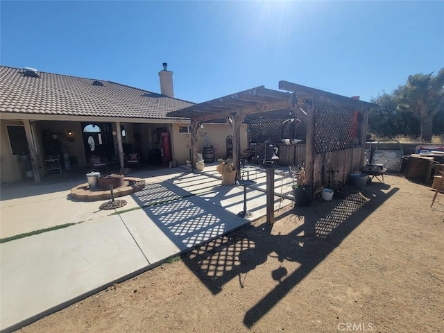 view of patio / terrace featuring a pergola and a fire pit