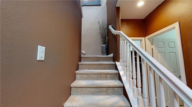 staircase with a textured wall