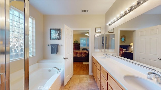 full bath featuring a wealth of natural light, visible vents, ensuite bath, and a sink