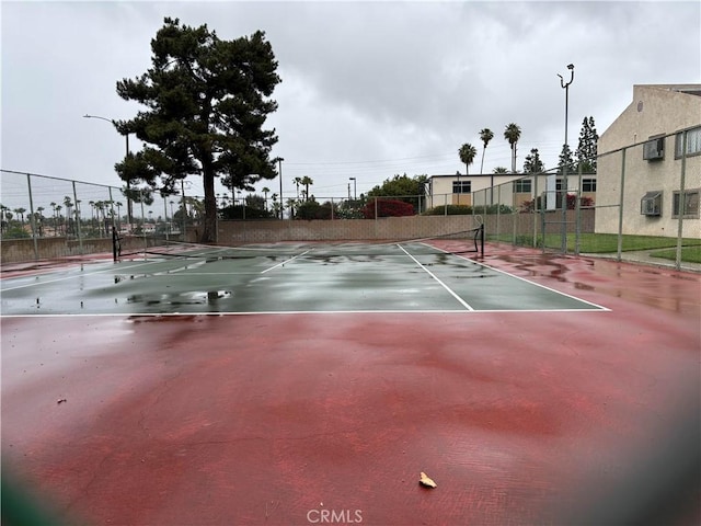 view of sport court featuring fence