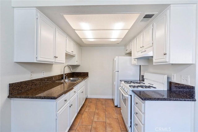 1251 S Meadow Ln Unit 145, Colton, CA 92324 - kitchen with white range with gas stovetop, a sink, under cabinet range hood, white cabinetry, and baseboards