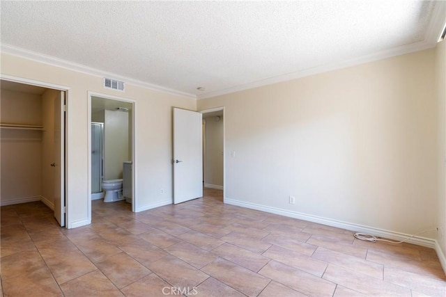 1251 S Meadow Ln Unit 145, Colton, CA 92324 - unfurnished bedroom featuring a textured ceiling, a walk in closet, crown molding, a closet, and ensuite bath