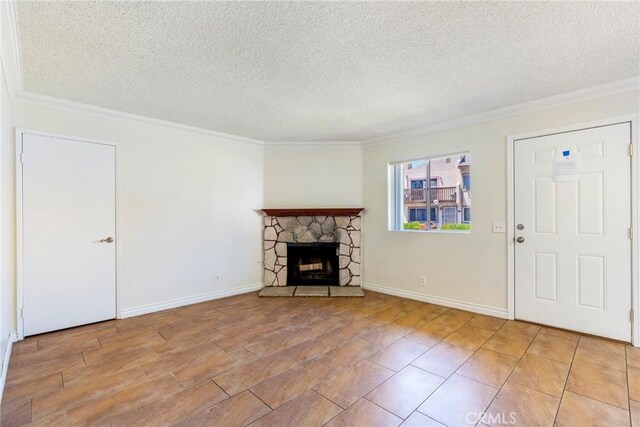 1251 S Meadow Ln Unit 145, Colton, CA 92324 - unfurnished living room with crown molding, a textured ceiling, a fireplace, and baseboards