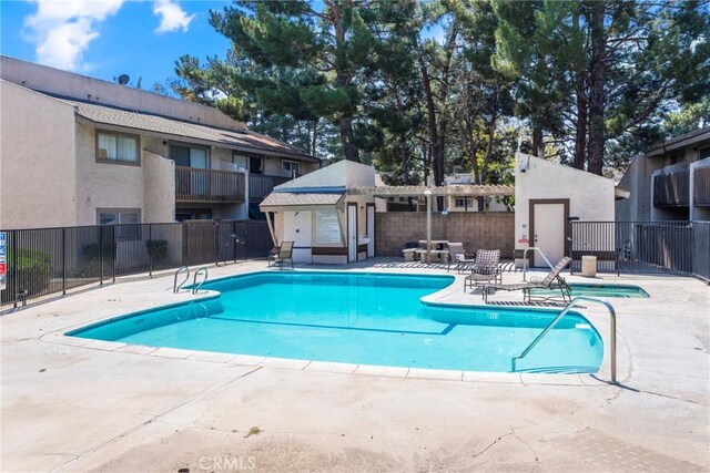 1251 S Meadow Ln Unit 145, Colton, CA 92324 - community pool with fence and a patio