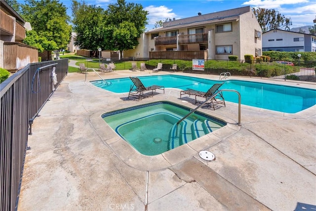 1251 S Meadow Ln Unit 145, Colton, CA 92324 - community pool with a hot tub, fence, and a patio