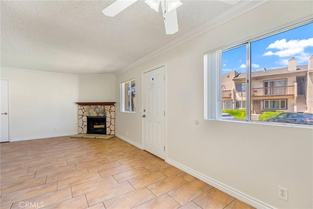 1251 S Meadow Ln Unit 145, Colton, CA 92324 - unfurnished living room featuring a textured ceiling, a stone fireplace, ornamental molding, ceiling fan, and baseboards