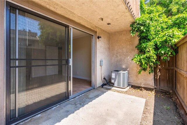 1251 S Meadow Ln Unit 145, Colton, CA 92324 - view of patio featuring cooling unit and fence
