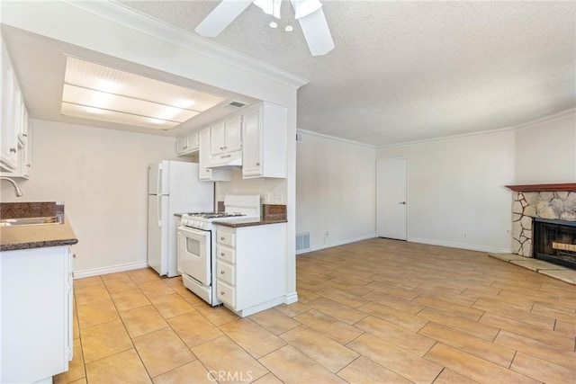 1251 S Meadow Ln Unit 145, Colton, CA 92324 - kitchen with white appliances, dark countertops, a sink, a ceiling fan, and a textured ceiling