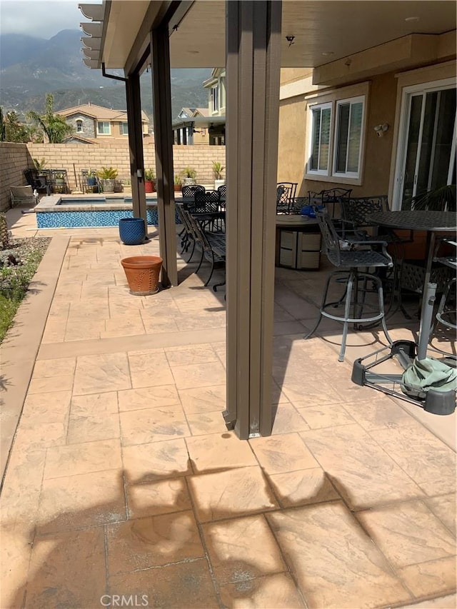 5230 Starling St, Fontana, CA 92336 - view of patio / terrace featuring outdoor dining space, a mountain view, a fenced in pool, and a fenced backyard