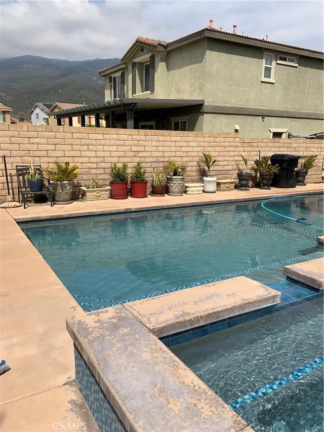 5230 Starling St, Fontana, CA 92336 - view of swimming pool featuring a mountain view, a fenced in pool, and fence
