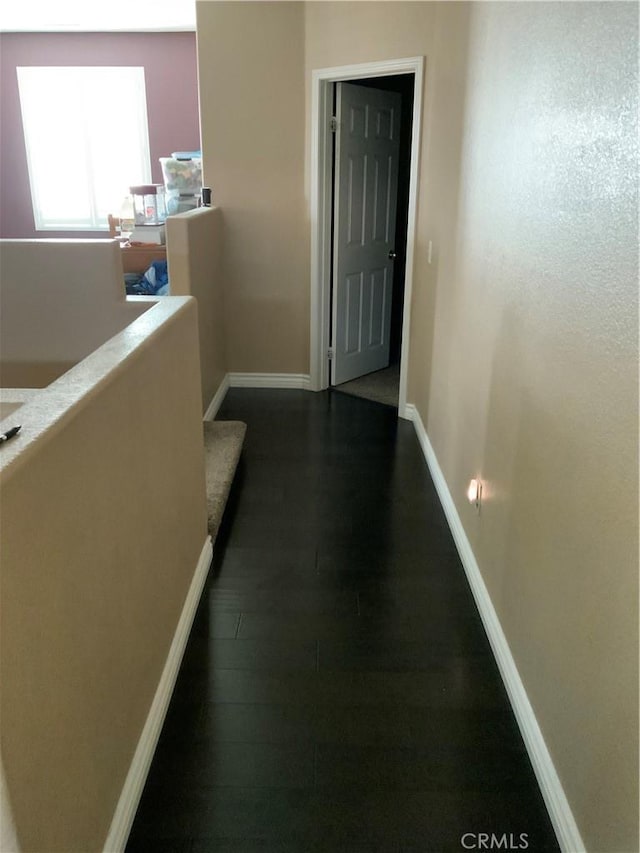 5230 Starling St, Fontana, CA 92336 - hallway featuring dark wood-type flooring and baseboards