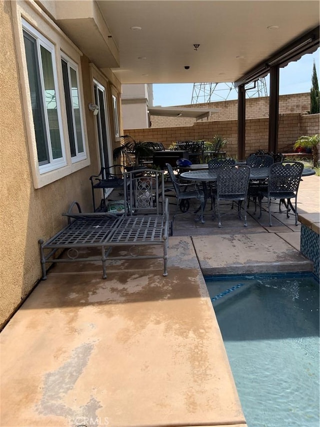 5230 Starling St, Fontana, CA 92336 - view of patio featuring outdoor dining space, fence, and a fenced in pool