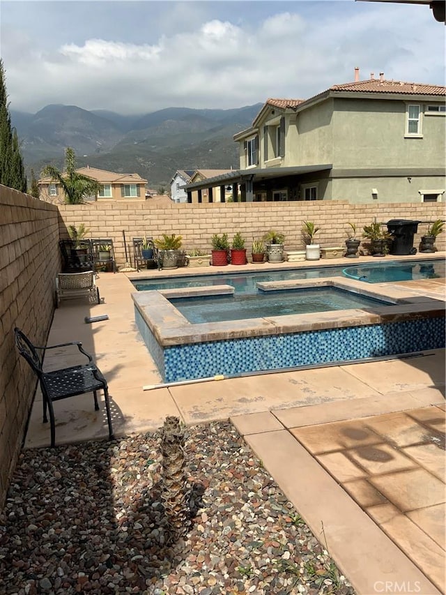 5230 Starling St, Fontana, CA 92336 - view of pool with a fenced backyard, a patio, an in ground hot tub, a mountain view, and a fenced in pool