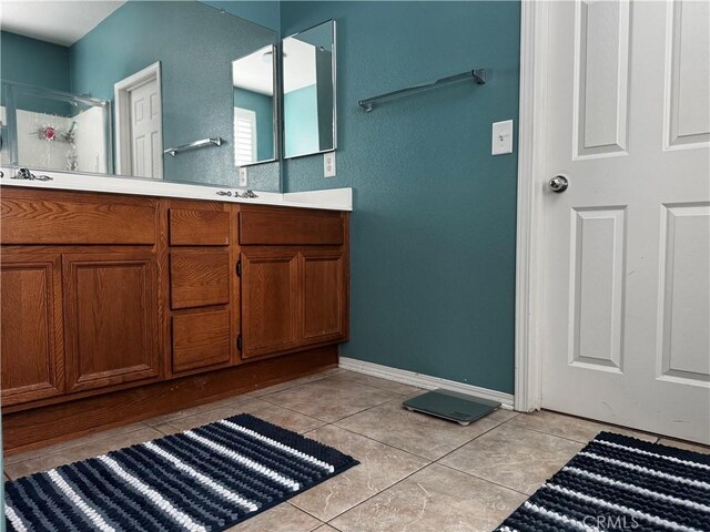 5230 Starling St, Fontana, CA 92336 - full bath featuring a shower stall, a sink, tile patterned floors, double vanity, and baseboards
