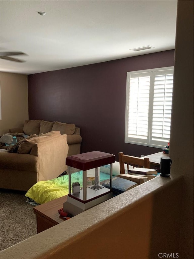 5230 Starling St, Fontana, CA 92336 - carpeted living area with visible vents and a ceiling fan