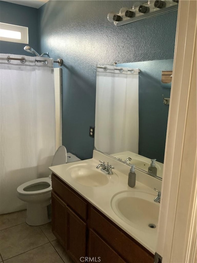 5230 Starling St, Fontana, CA 92336 - bathroom with tile patterned floors, double vanity, a sink, and toilet