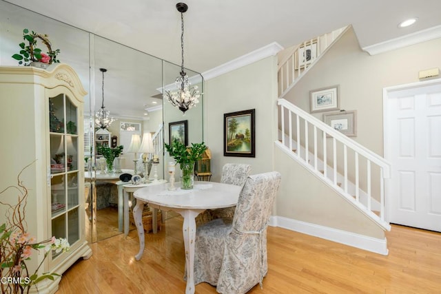 dining area featuring stairs, a notable chandelier, crown molding, and light wood-style flooring