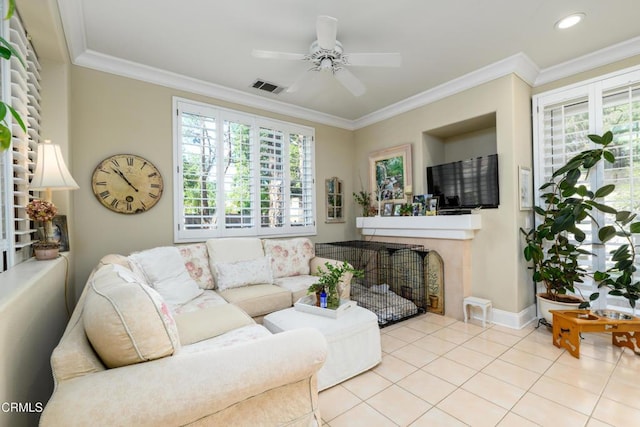 living area featuring crown molding, a healthy amount of sunlight, and visible vents
