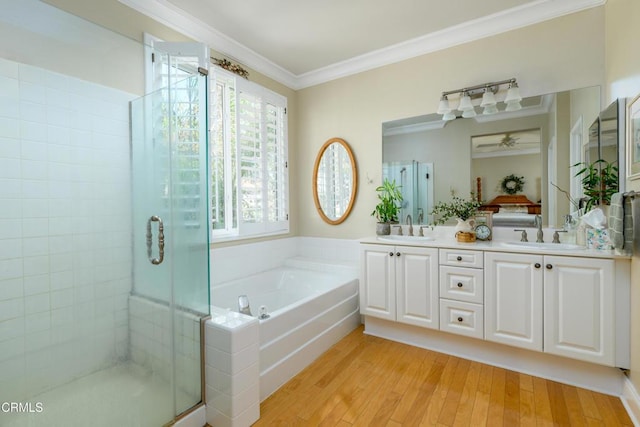 bathroom featuring ornamental molding, a sink, and a shower stall