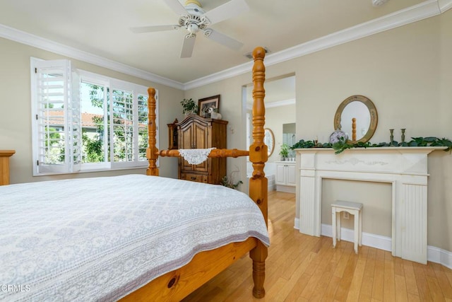 bedroom featuring crown molding, baseboards, light wood finished floors, and ceiling fan