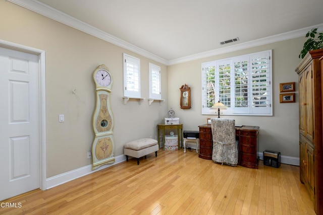 living area featuring light wood finished floors, a wealth of natural light, and ornamental molding